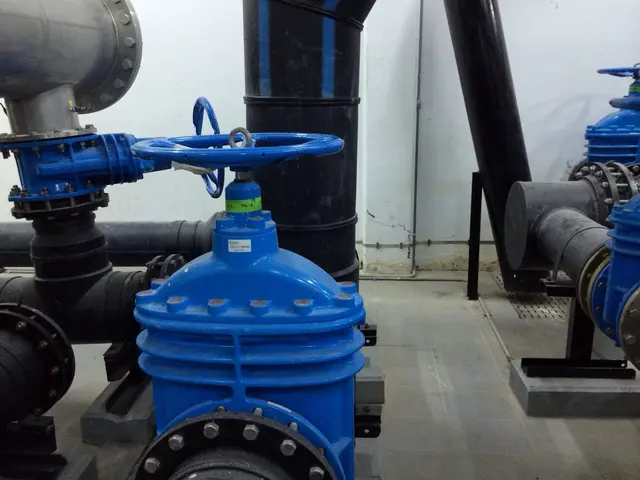 Blue gate valve on HDPE pipework in a Kuwait mechanical plant room