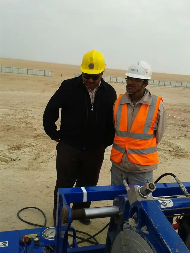 Engineers inspecting an HDPE butt-fusion machine on a desert site in Kuwait