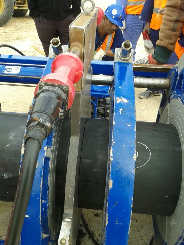 Operator butt-fusion welding HDPE pipe with a hydraulic machine in Kuwait