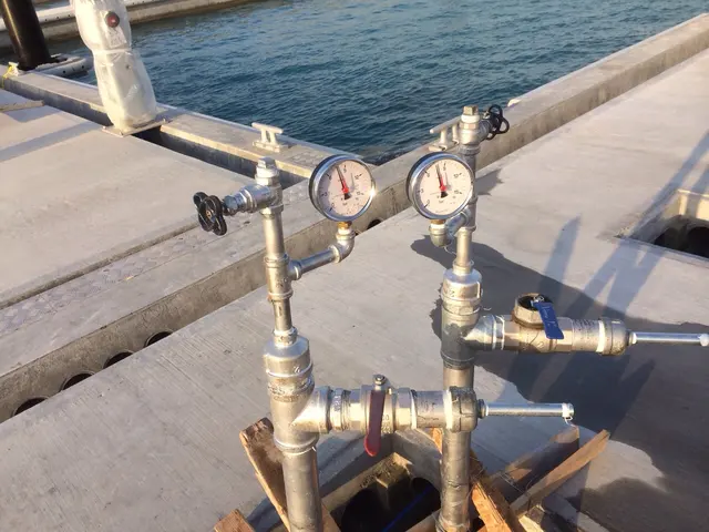 Stainless pressure-gauge manifold on HDPE pipework at a Kuwait waterfront jetty