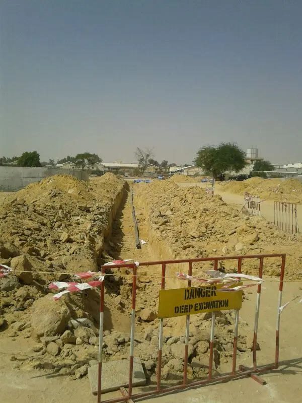 Deep excavation trench for a pipeline behind a danger barrier on a Kuwait site