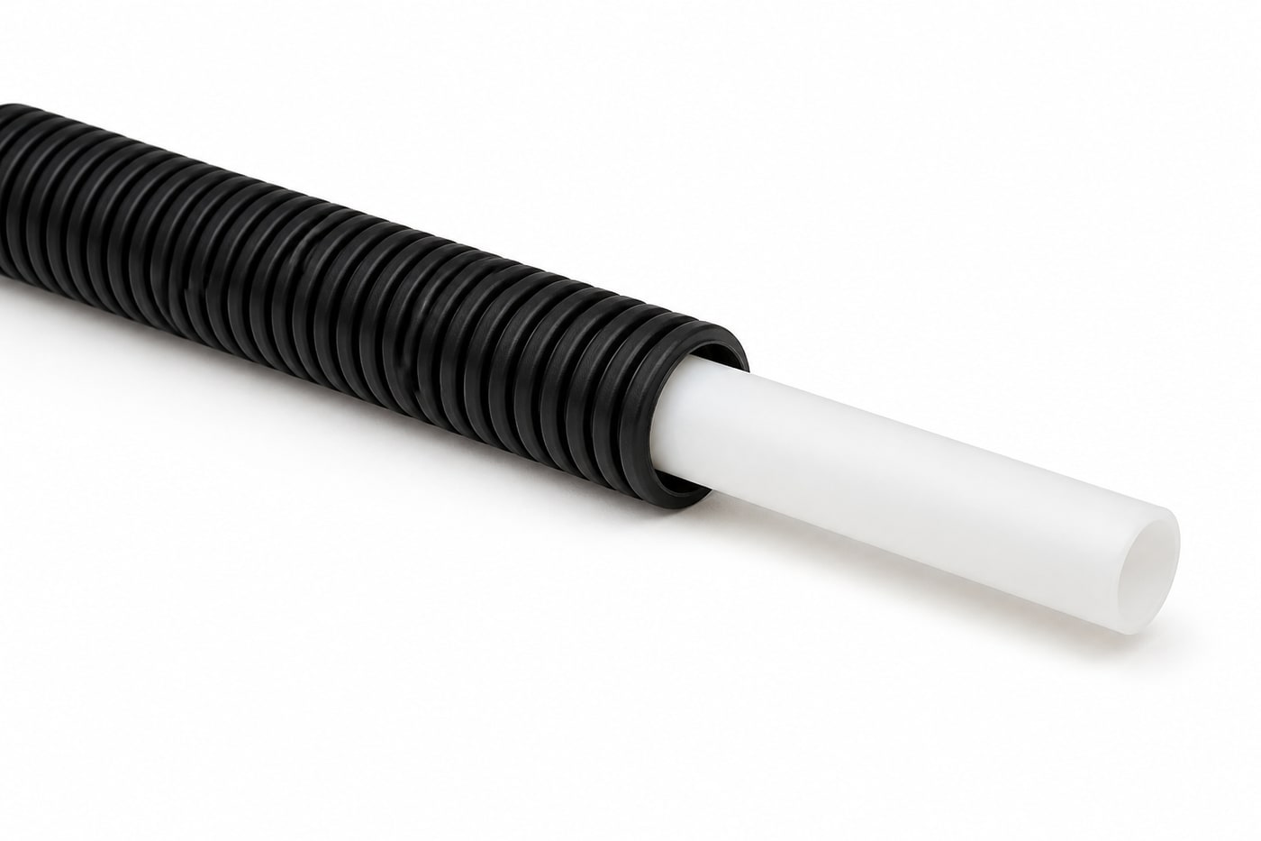 White PE-Xa PEX pipe emerging from a black corrugated HDPE conduit